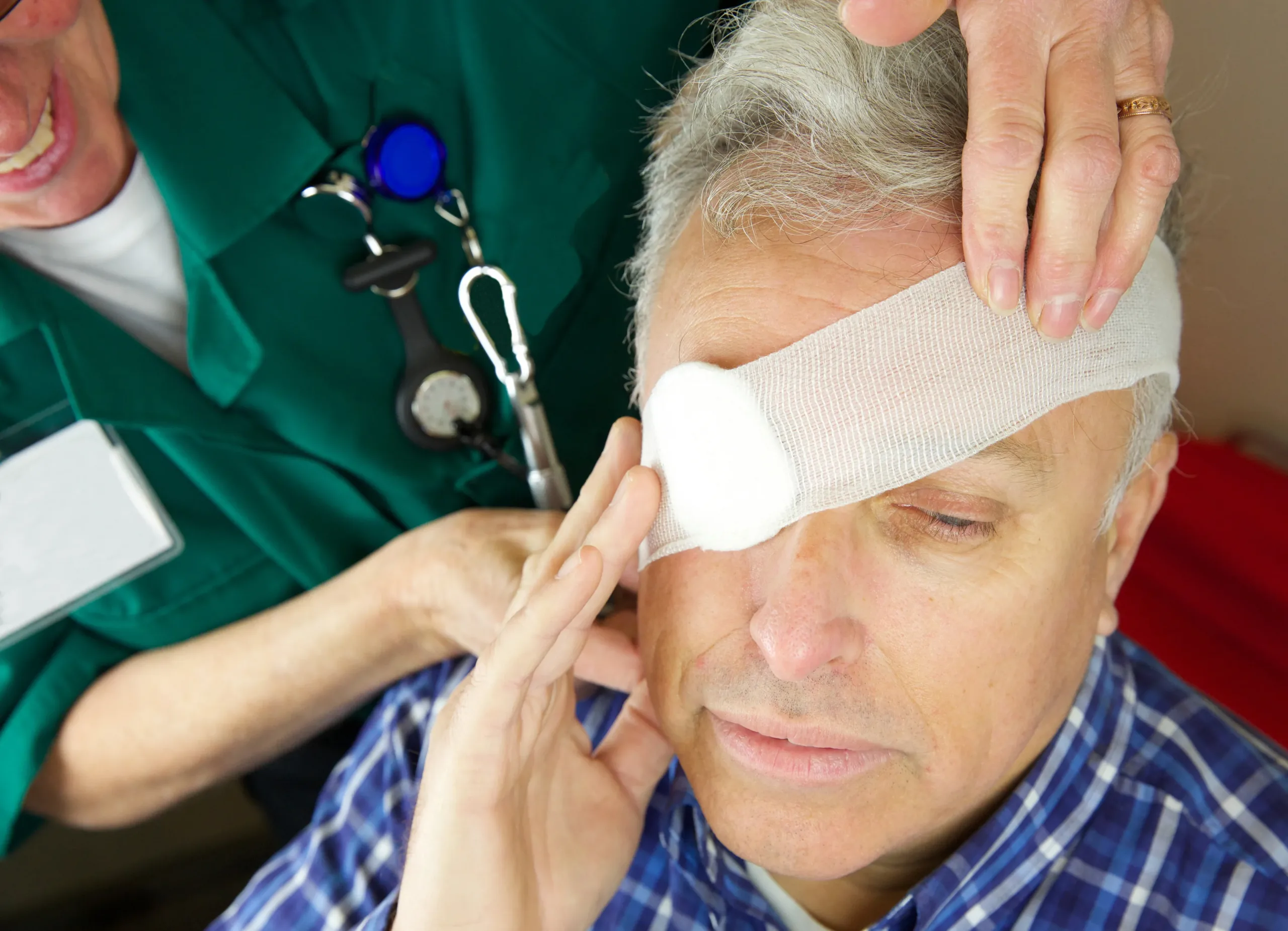 Doctor applies eye patch to man with injury 